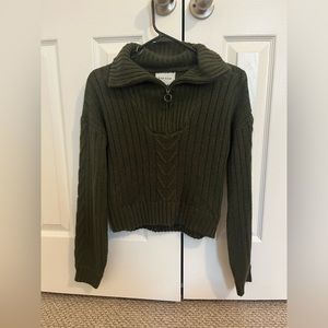 Woman’s green half zip sweater